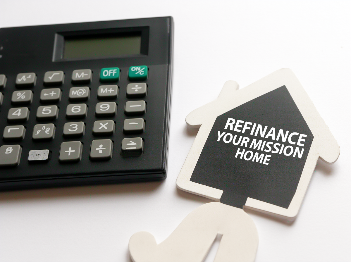 A black calculator next to a house-shaped sign that reads "Refinance Your Mission Home" on a white background.