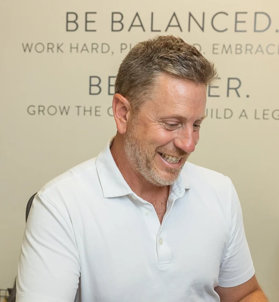 Dave Browne working at his laptop in the Browne Mortgage office