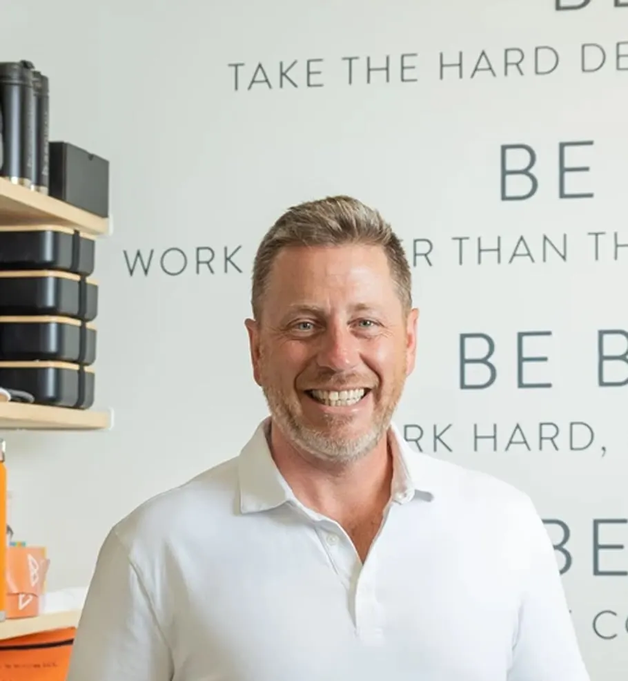 Dave Browne standing in front of the Browne Mortgage values wall