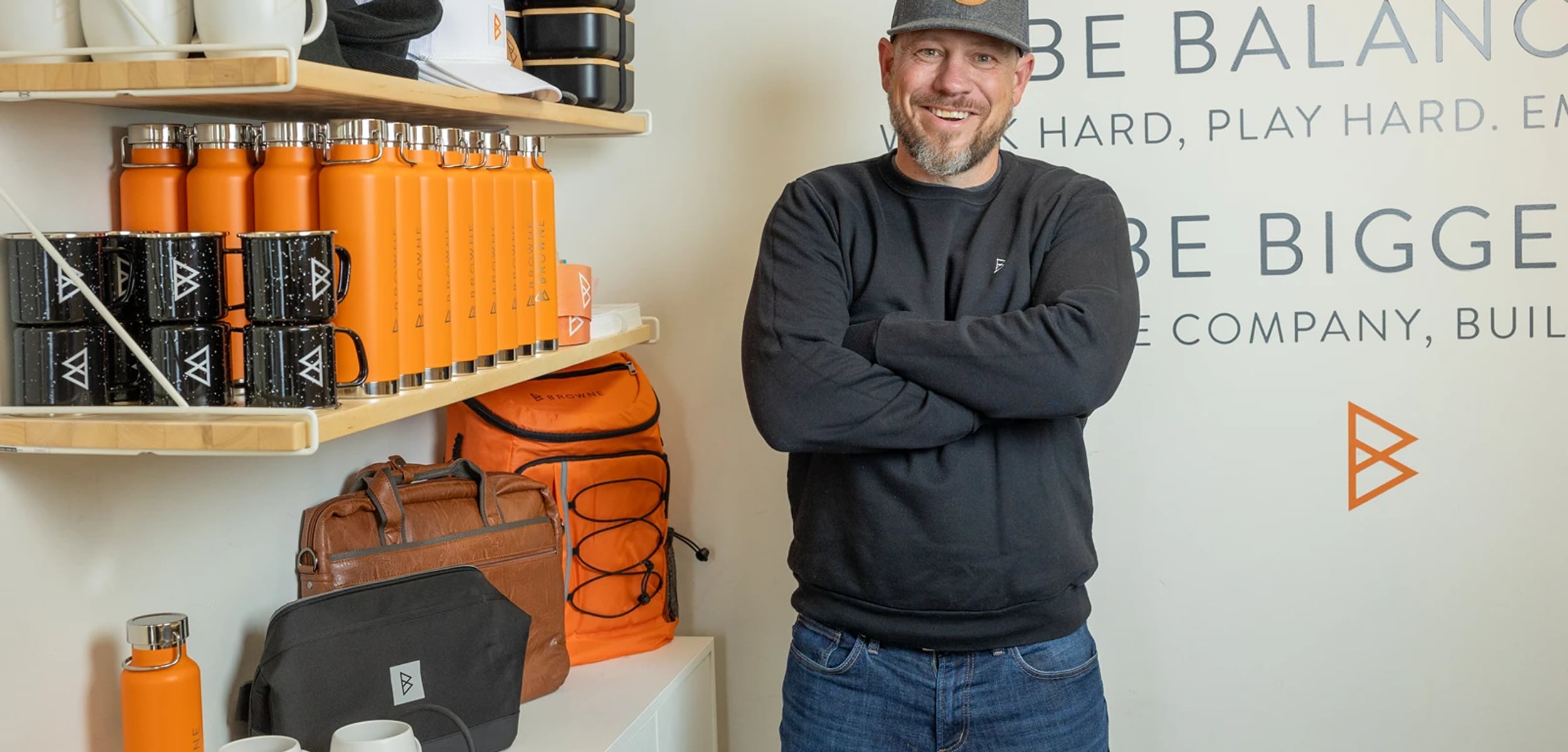 Jordi Browne in a Browne Mortgage cap, arms crossed, in the office
