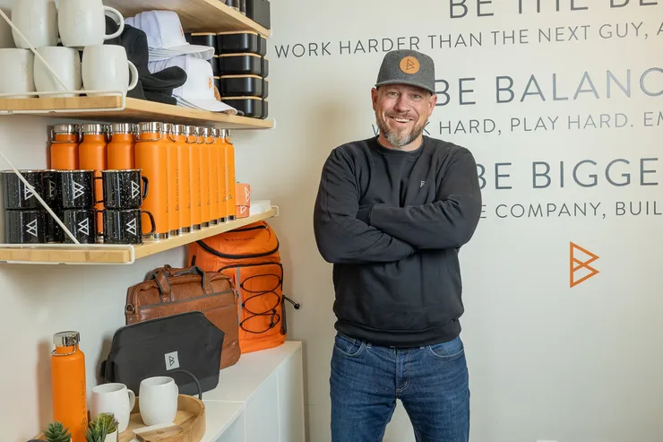Jordi Browne in a Browne Mortgage cap, arms crossed, in the office