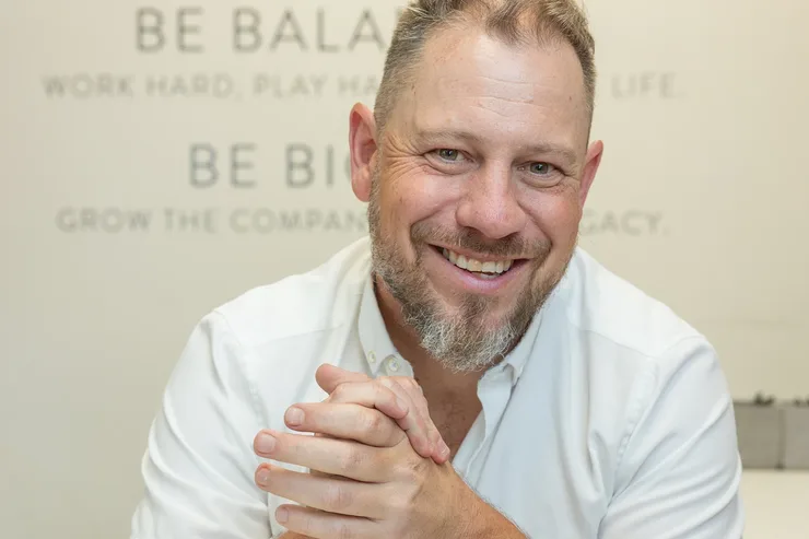 Jordi Browne smiling at his desk in the Browne Mortgage office